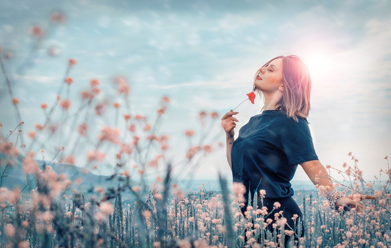 Woman embracing nature in Field of Flowers