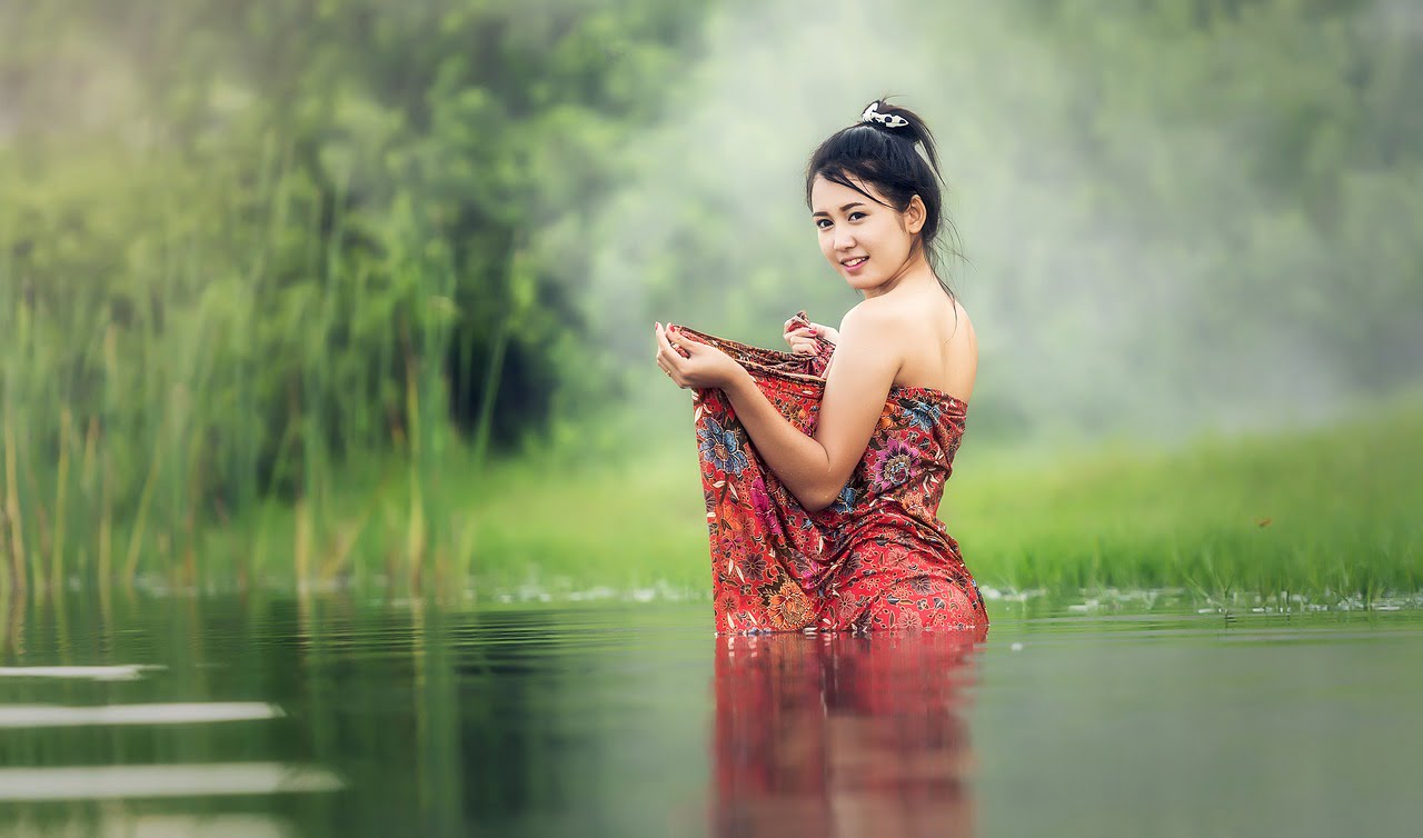 Asian culturally dressed woman in river