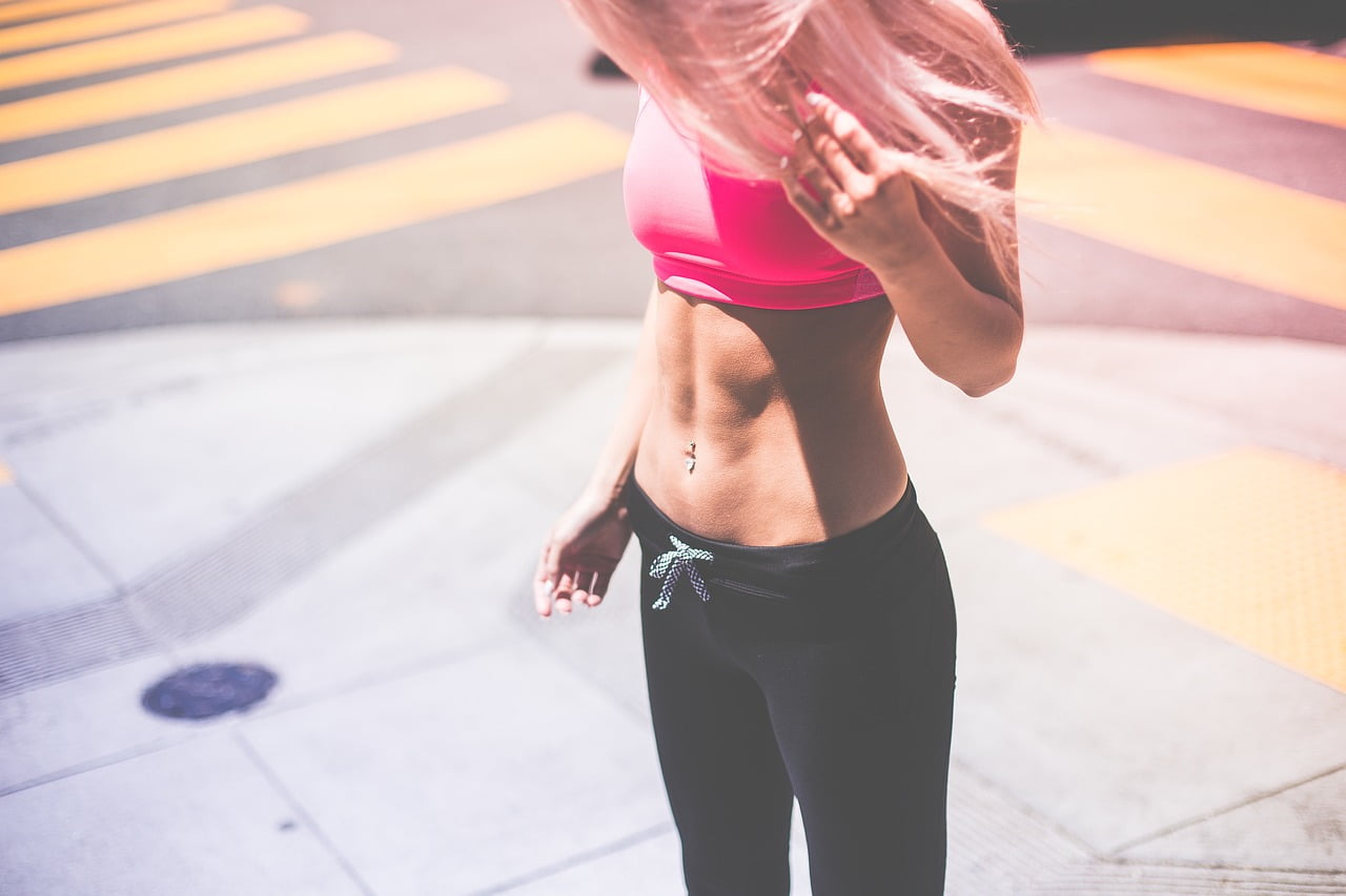 Girl in sport outfit showing off her abs