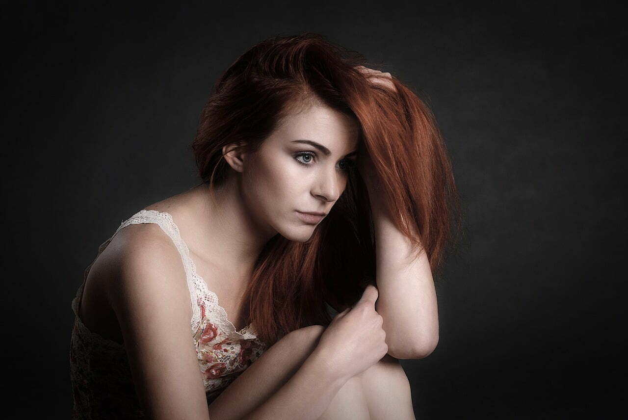 Young girl sitting on floor - concerned