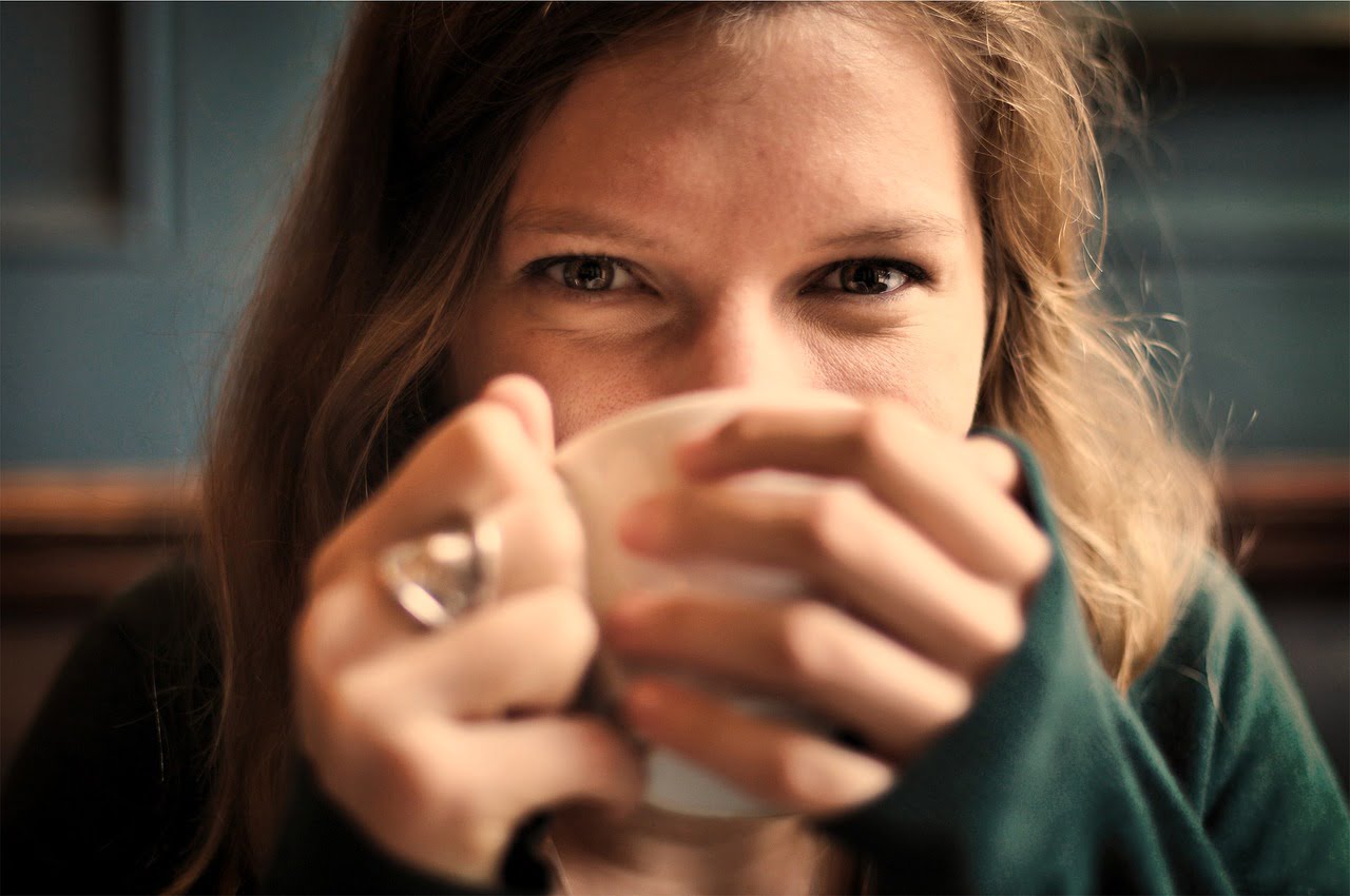 woman smiling drinking coffee