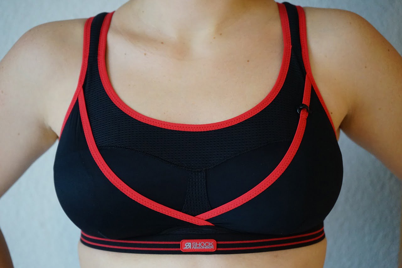 woman black and red sports bra reflecting anti-aging
