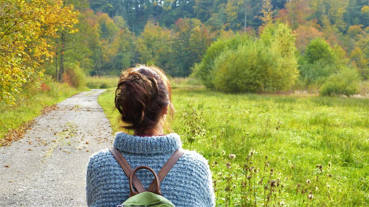 woman on road in woods