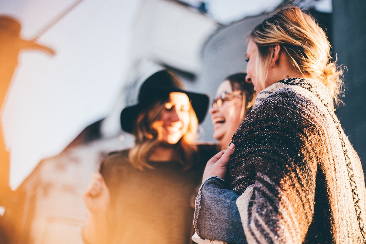 3 women talking and laughing