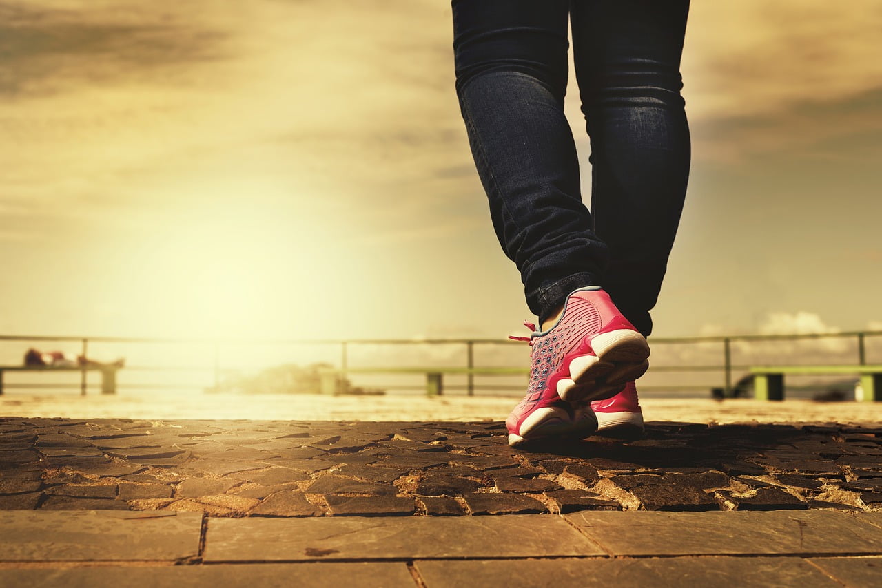 woman walking pink running shoes