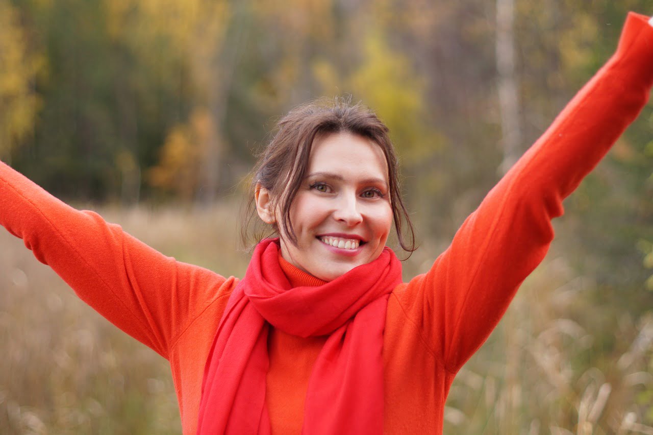 woman happy arms raised