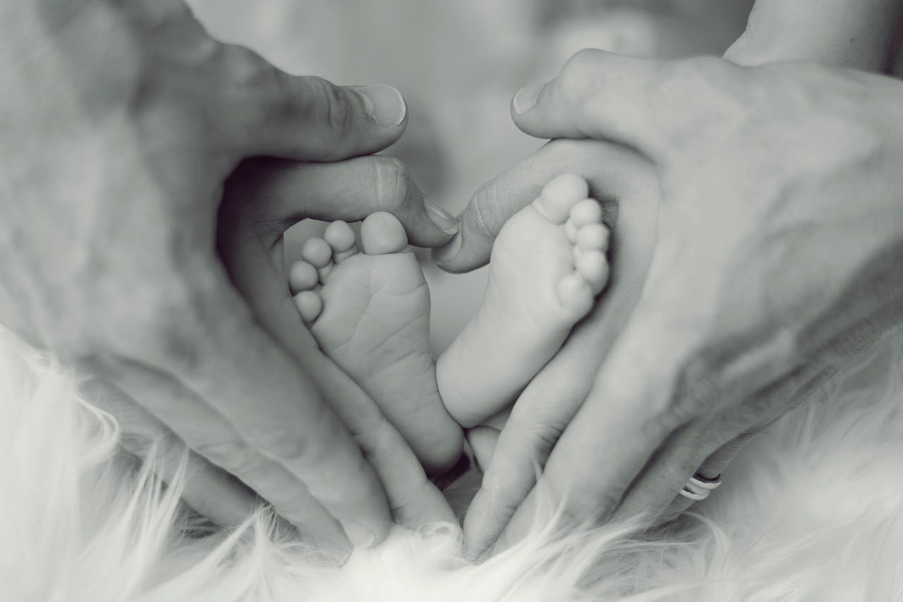 parents hands baby's feet