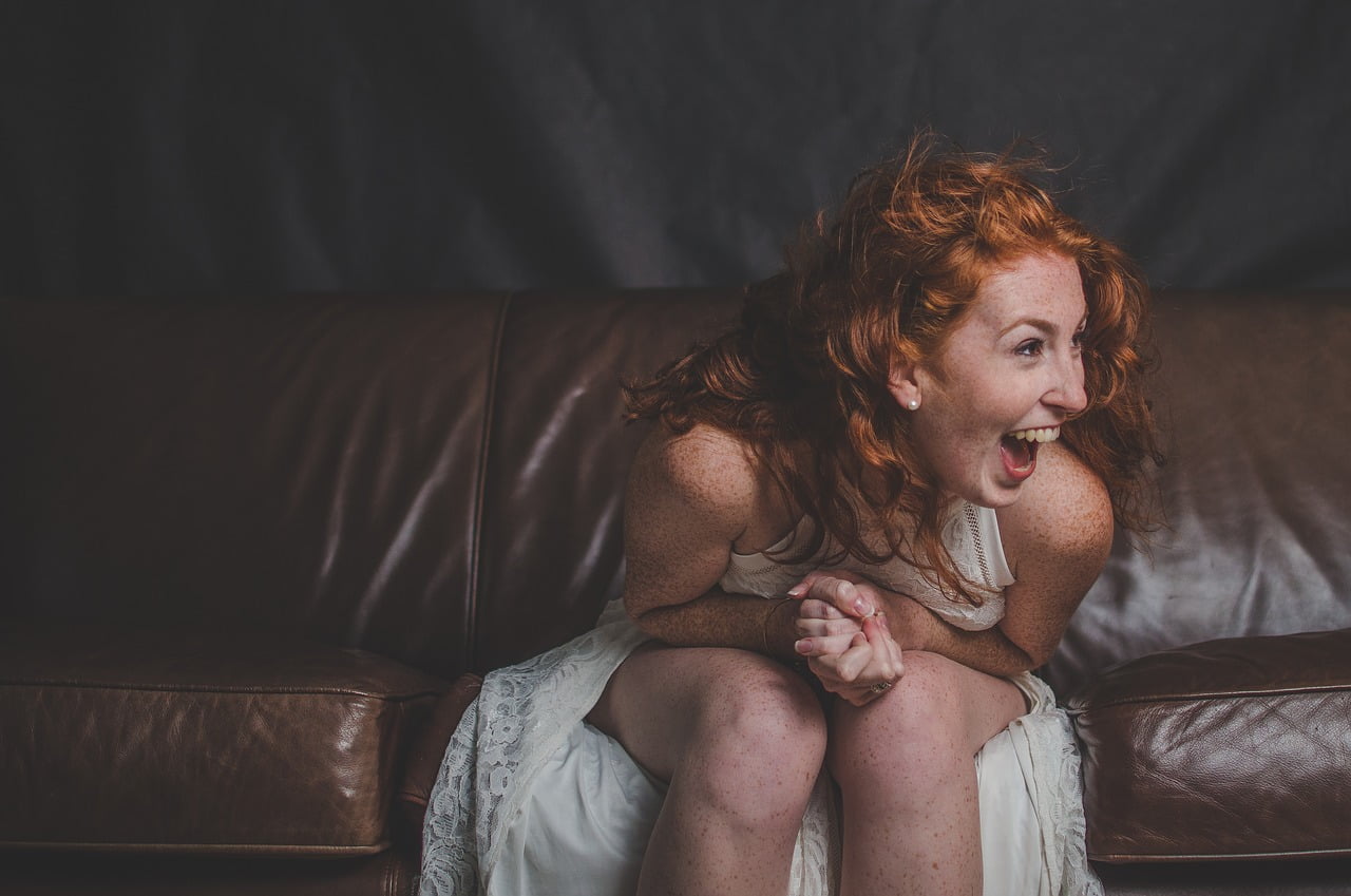 woman laughing on couch