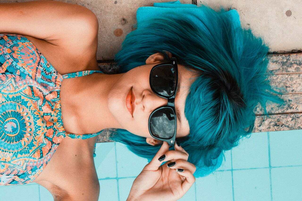 woman blue hair and sunglasses
