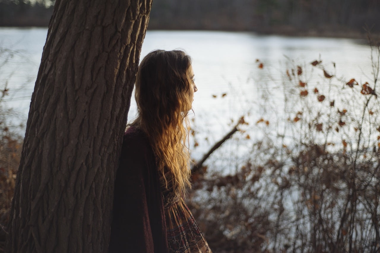 woman by tree contemplating