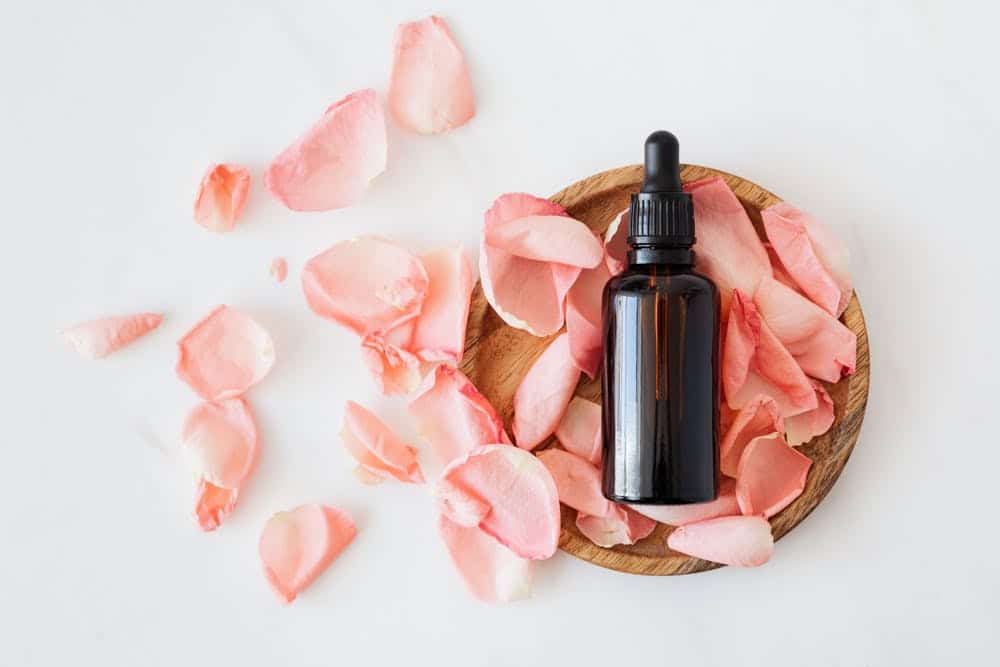 A picture of a bottle of almond oil with flowers